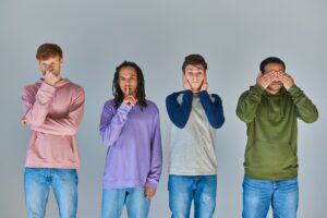 four men showing gestures of four monkeys, hear, see, speak and do no evil, cultural diversity