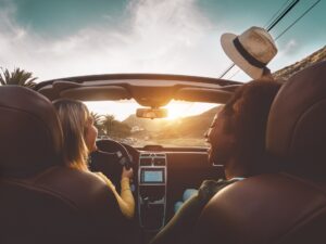 Happy girls doing road trip in tropical city