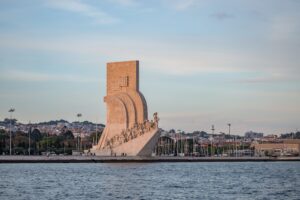 Monument of Discoveries surrounded by the sea and buildings in Portugal