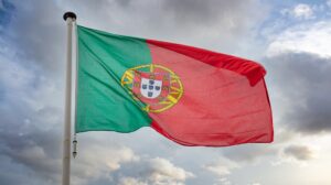 Portugal flag waving against cloudy sky
